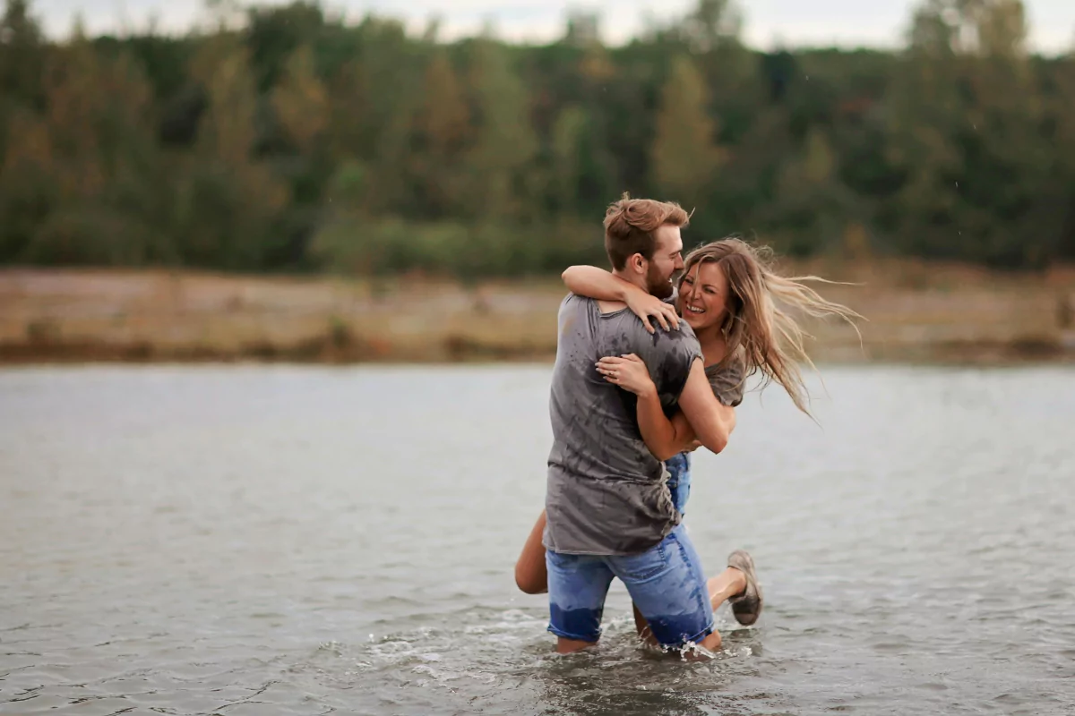 Image of a securely attached couple playing in a body of water