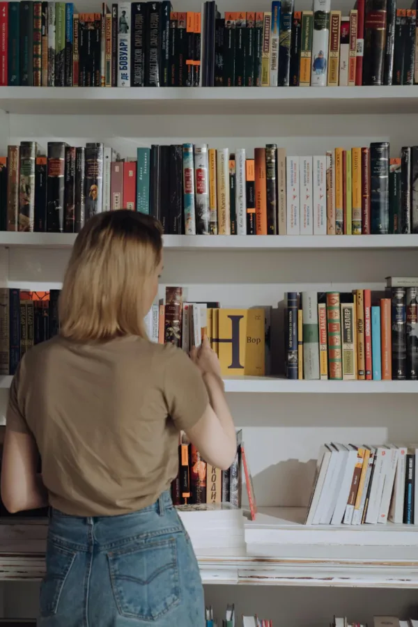 A woman shelving books to represent how the mind is similar to a library.