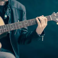 Man with musical intelligence holding a guitar